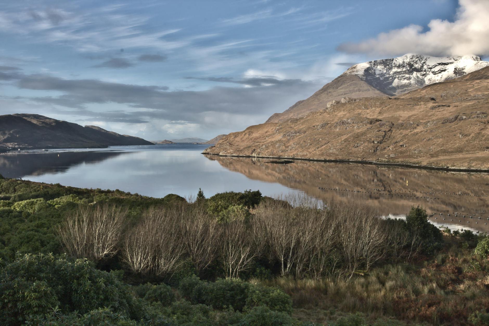 snow capped mountain beside a lake